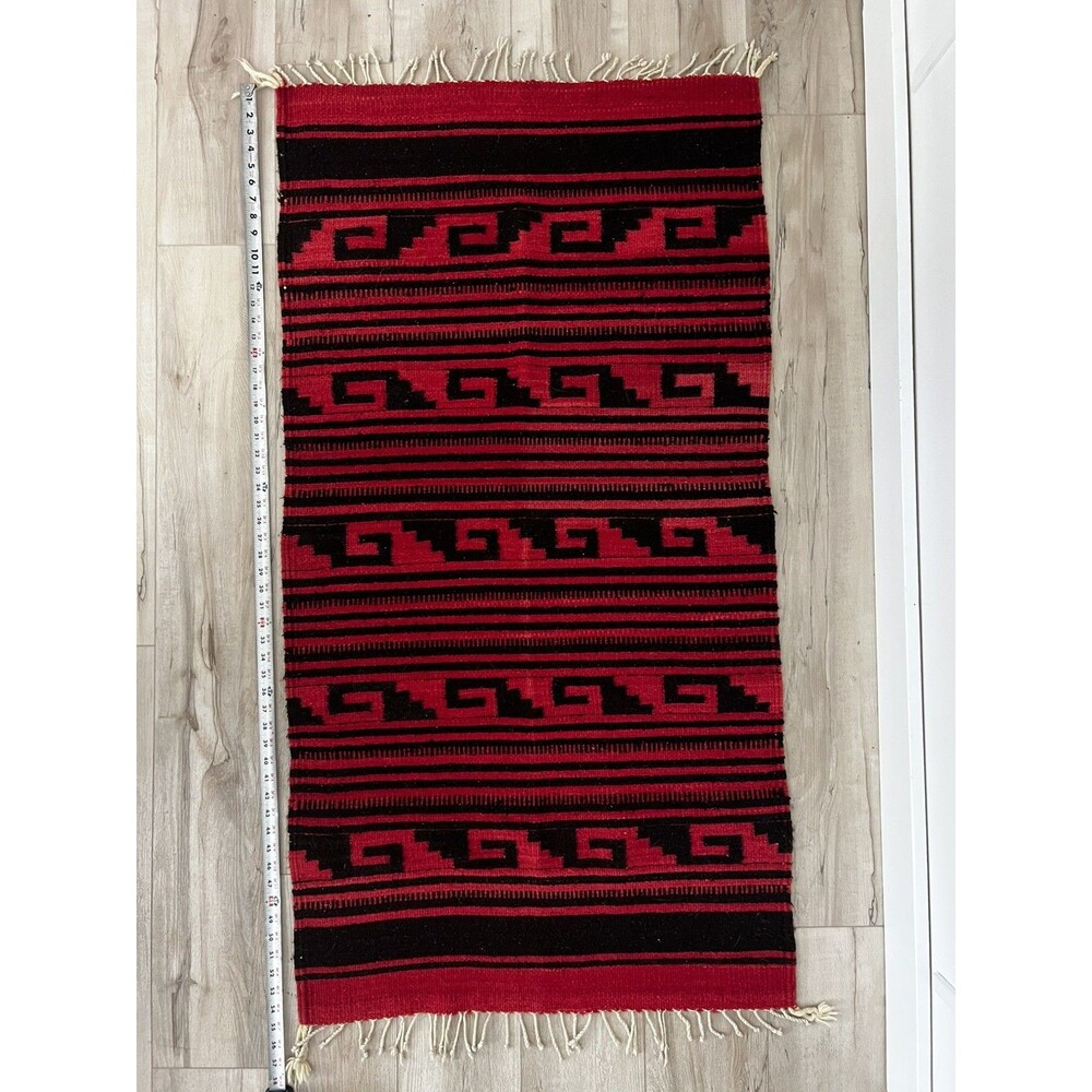 Vintage Handwoven Zapotec wool rug/blanket, black wave pattern, red background.